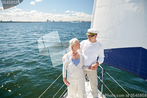 Image of senior couple hugging on sail boat or yacht in sea