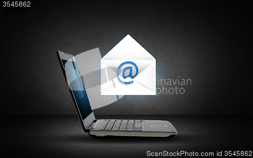 Image of laptop computer with e-mail icon and letter