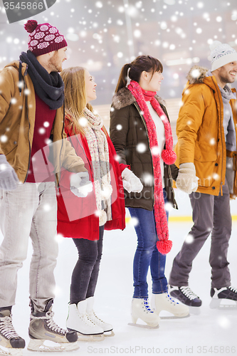 Image of happy friends on skating rink