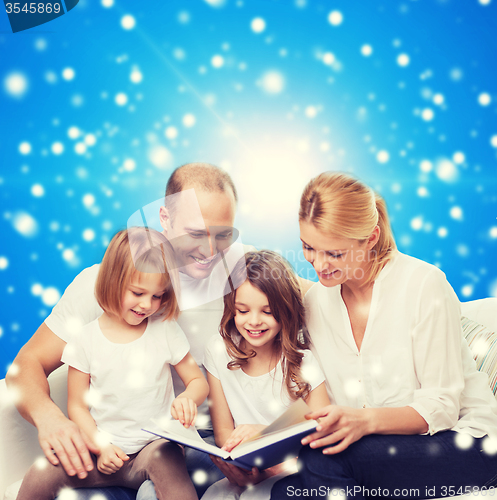 Image of happy family with book at home