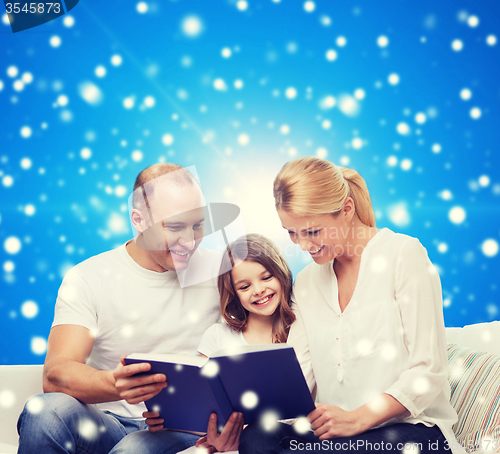 Image of happy family with book at home