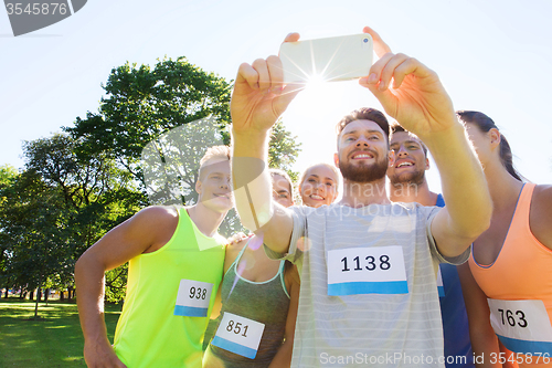 Image of teenage sportsmen taking selfie with smartphone