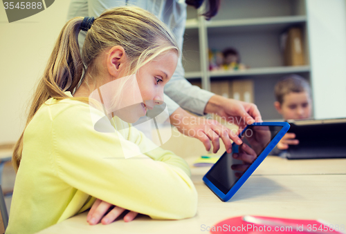 Image of little girl with teacher and tablet pc at school