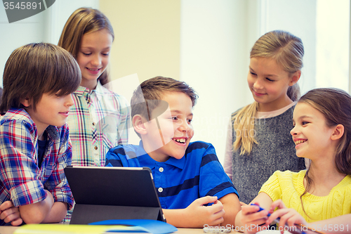 Image of group of school kids with tablet pc in classroom