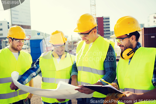 Image of group of builders with tablet pc and blueprint