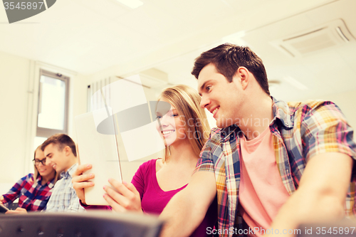 Image of group of smiling students with tablet pc