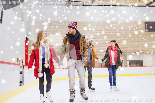 Image of happy friends on skating rink