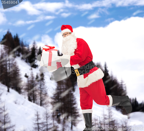 Image of man in costume of santa claus with gift box