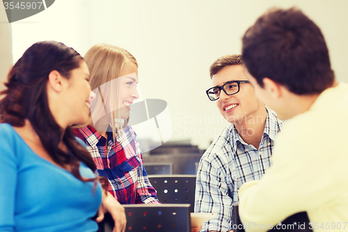 Image of group of smiling students in lecture hall