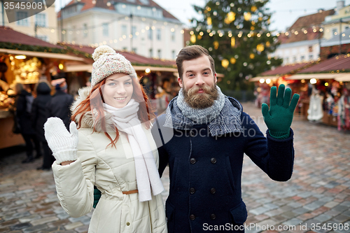 Image of happy couple walking in old town