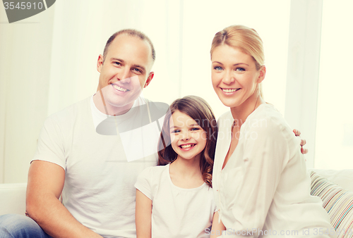Image of smiling parents and little girl at home