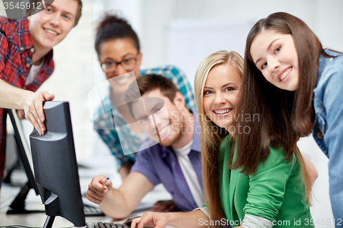 Image of happy high school students in computer class