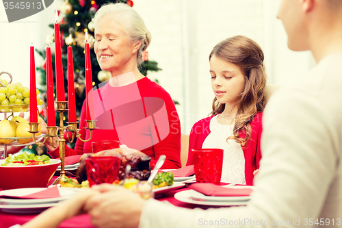 Image of smiling family having holiday dinner at home