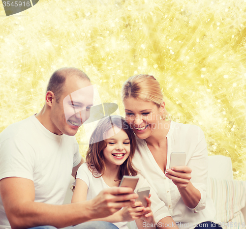 Image of happy family with smartphones