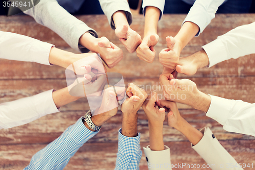 Image of business team showing thumbs up