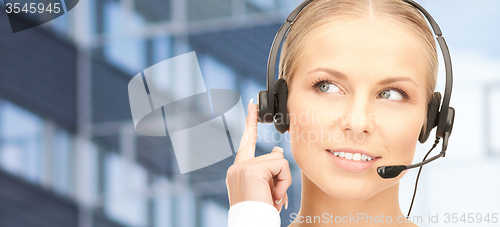 Image of helpline operator in headset over business center