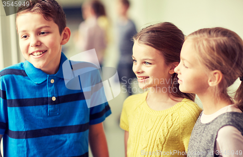 Image of group of smiling school kids talking in corridor