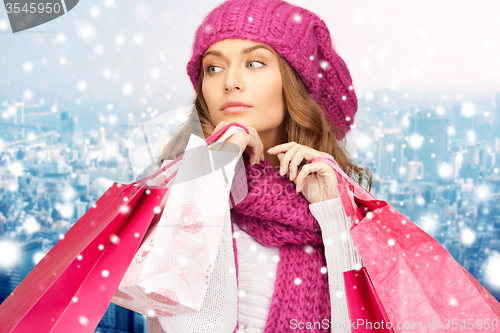 Image of young woman in winter clothes with shopping bags