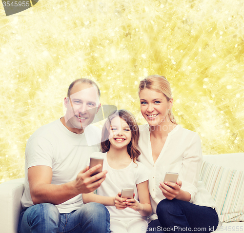 Image of happy family with smartphones