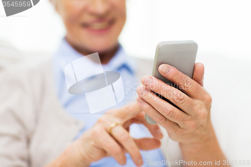 Image of close up of senior woman with smartphone texting