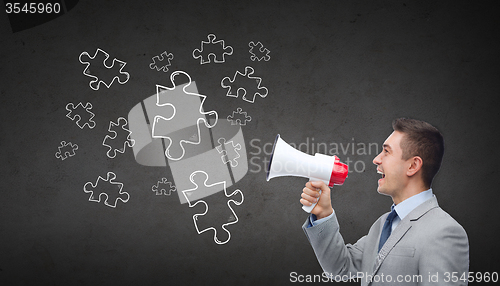 Image of happy businessman in suit speaking to megaphone