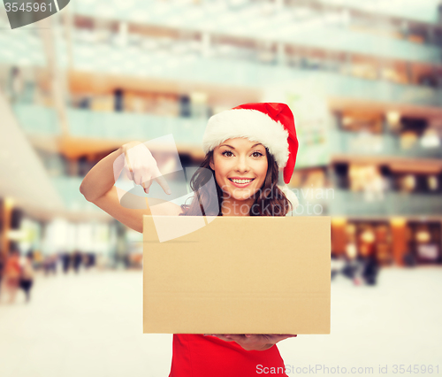 Image of smiling woman in santa helper hat with parcel box