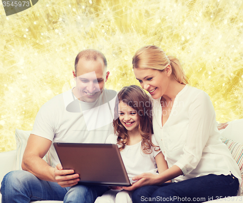 Image of smiling family with laptop