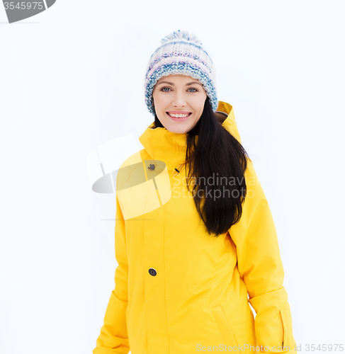 Image of happy young woman in winter clothes outdoors