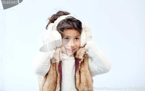 Image of happy little girl wearing earmuffs