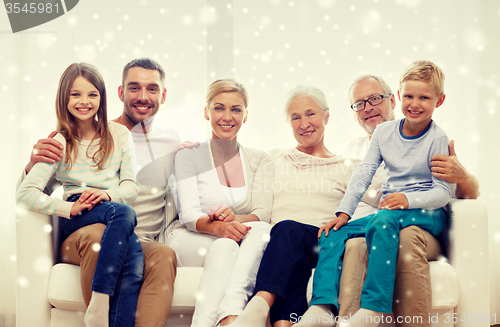 Image of happy family sitting on couch at home