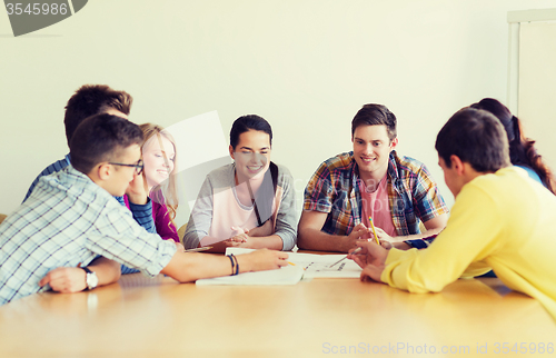 Image of group of smiling students with blueprint