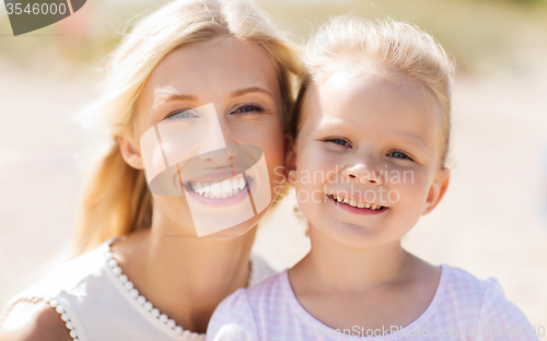 Image of happy mother and little daughter on summer beach