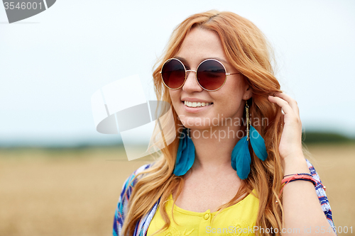 Image of smiling young redhead hippie woman outdoors