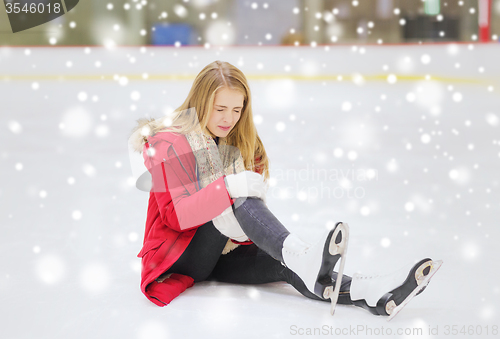 Image of young woman fell down on skating rink