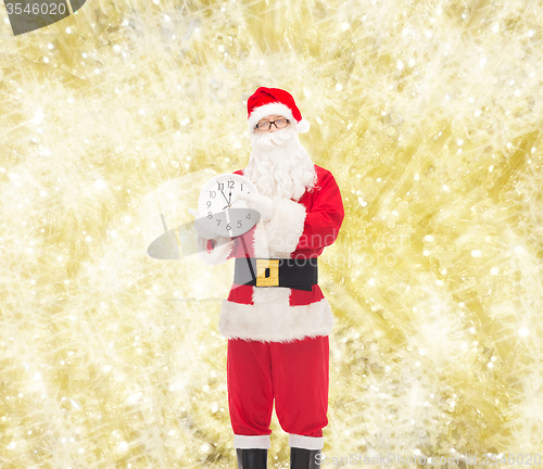 Image of man in costume of santa claus with clock