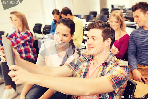 Image of group of smiling students with tablet pc