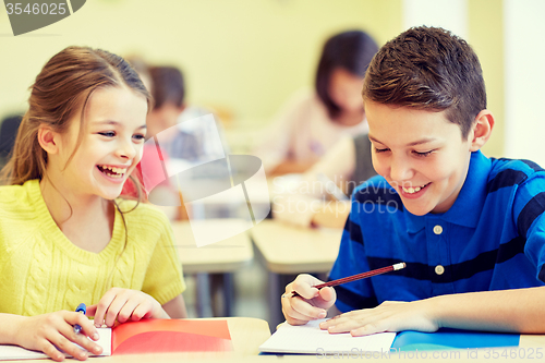 Image of group of school kids writing test in classroom