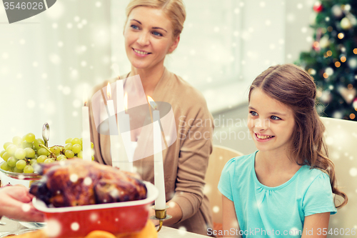 Image of smiling family having holiday dinner at home