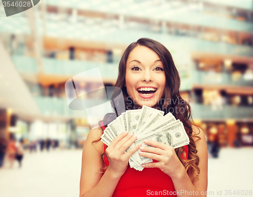 Image of woman in red dress with us dollar money