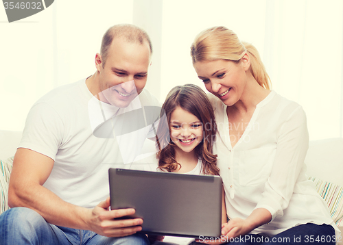 Image of parents and little girl with laptop at home