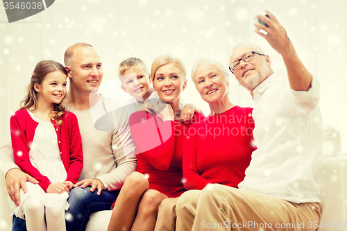 Image of smiling family with camera at home