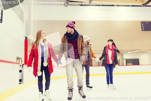 Image of happy friends on skating rink