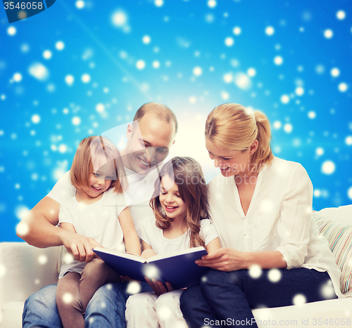 Image of happy family with book at home