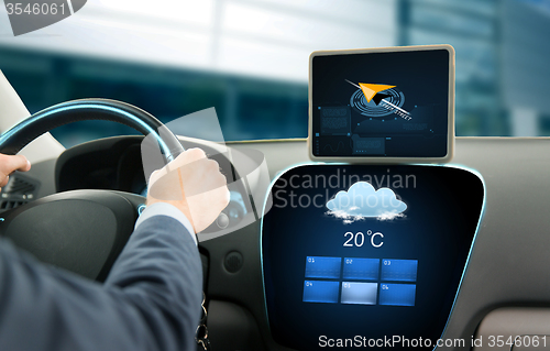 Image of close up of businessman with tablet pc driving car