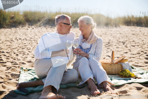 Image of happy senior couple talking on summer beach