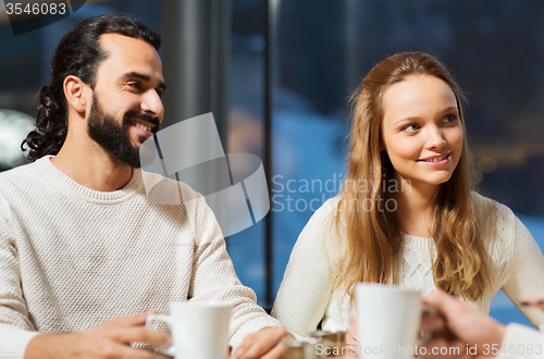 Image of happy couple meeting and drinking tea or coffee