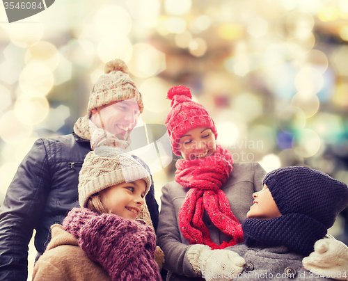 Image of happy family in winter clothes outdoors