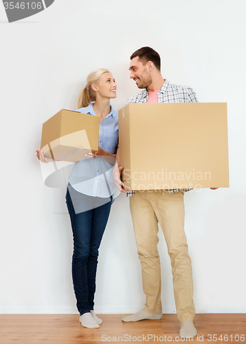 Image of couple with cardboard boxes moving to new home