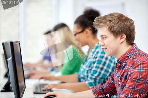 Image of happy high school students in computer class