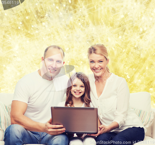 Image of smiling family with laptop
